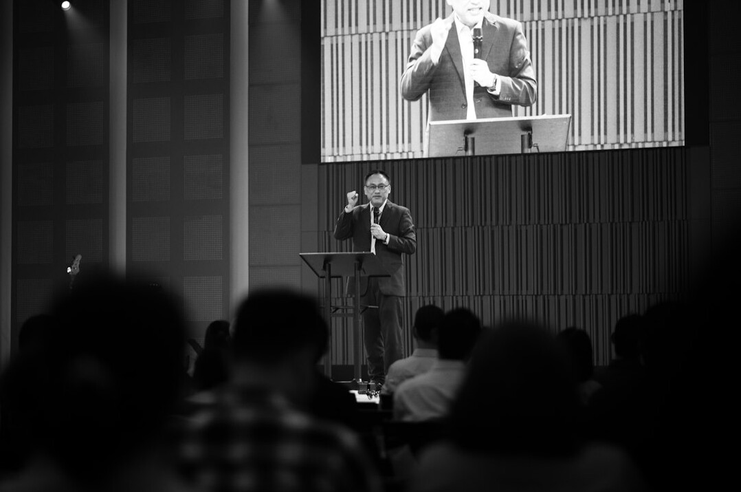 executive speaking on stage