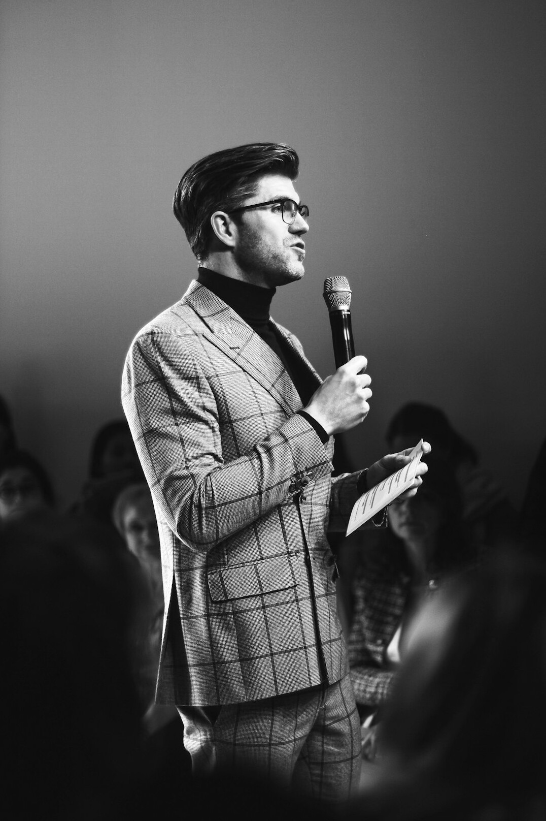 man in suit delivering speech